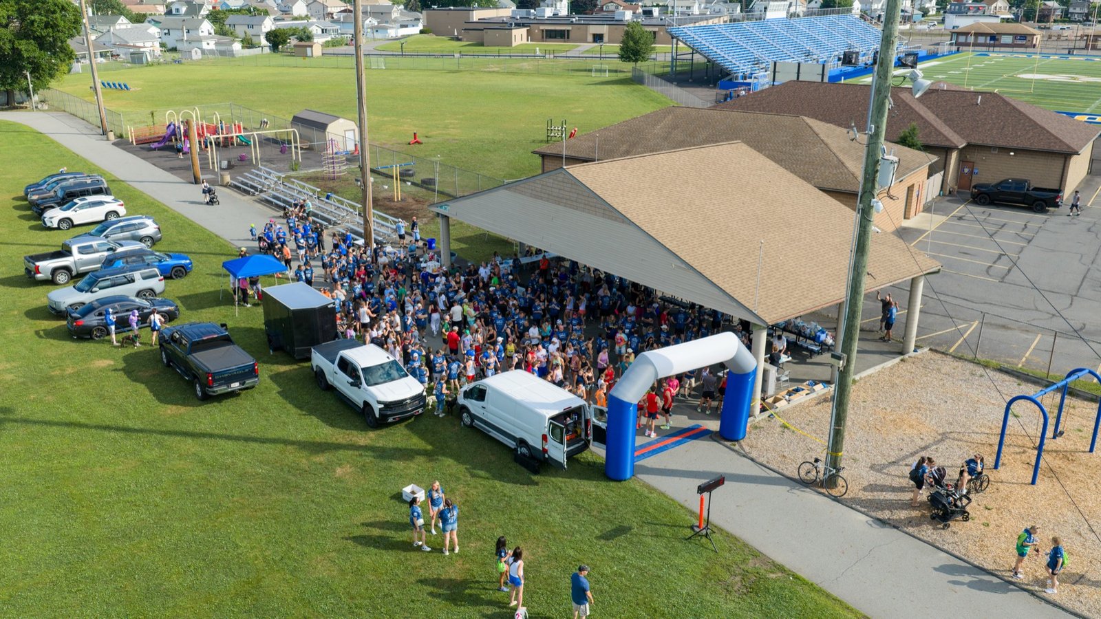 Crowd gathered at a community event pavilion